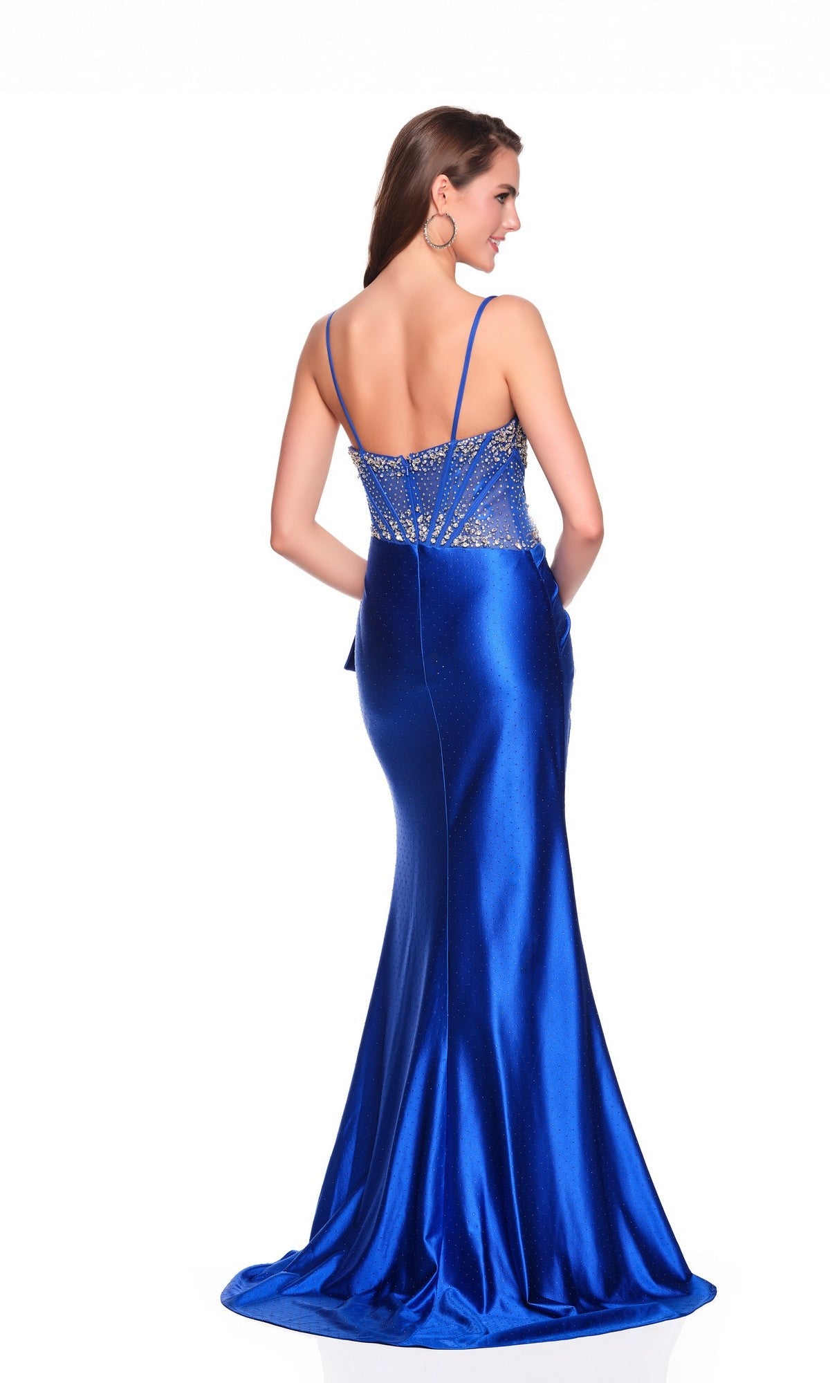 Woman wearing Dave and Johnny 12754, a fitted satin blue long prom dress with thin straps, embellished corset bodice, and daring thigh-high slit, standing and facing away.